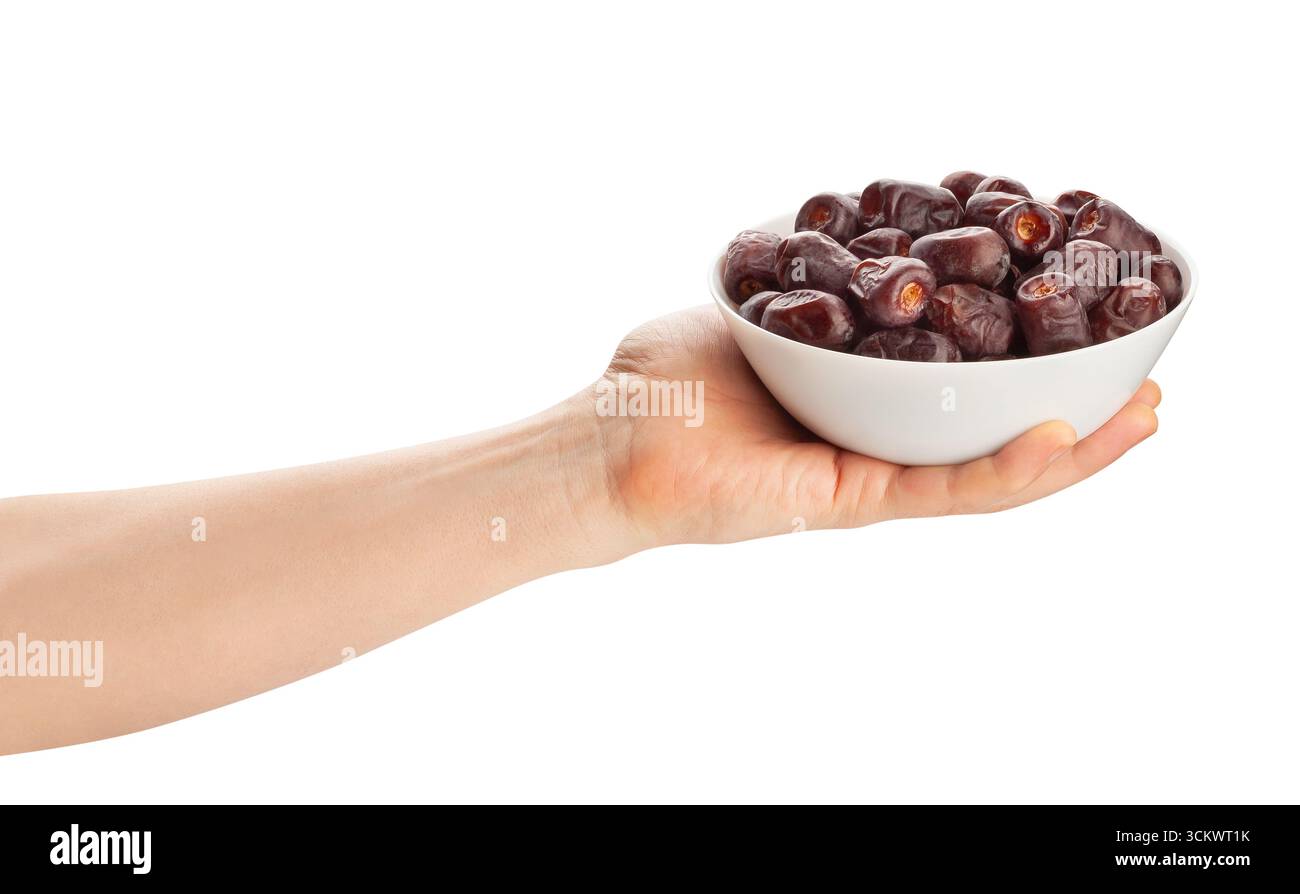 datteri frutto nel percorso della mano isolato sul bianco Foto Stock