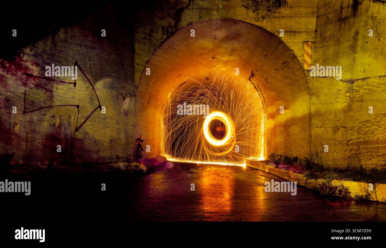 Lana d'acciaio Fotografia sotto un ponte mentre piove creando un'illuminazione spettacolare. Foto Stock