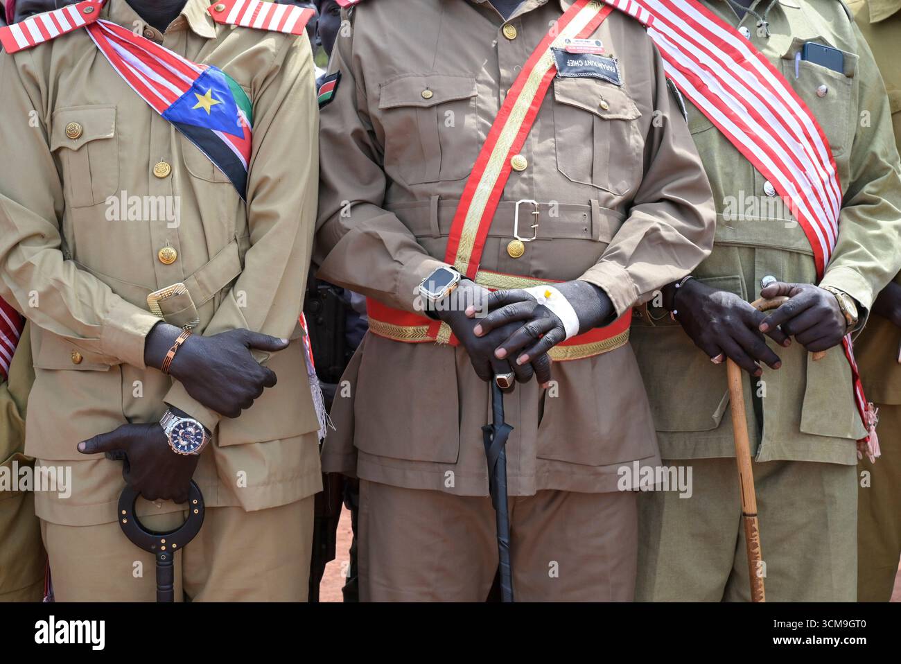 SUDAN DEL SUD, Stato dei Laghi, Rumbek, cerimonia funebre all'aeroporto per il defunto Governatore generale Matur Chut Dhuol , entourage dei funzionari del governo Dinka in uniforme con la fascia / SÜDSUDAN, Stato dei Laghi, Stadt Rumbek, Trauerzeremonie am Flughafen für den verstorbenen Gouverneur generale Matur Chut Dhuol, er War Gouverneur des Lakes State, Entourage von Regierungsbeammit ten Schärpe Foto Stock