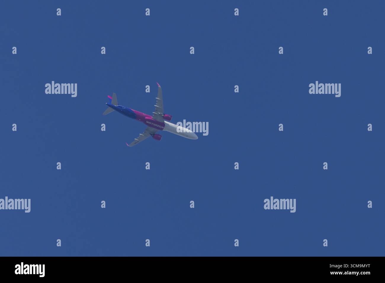 Airbus A321 jet di Wizz Air Airlines in volo in un cielo blu, Inghilterra, Regno Unito Foto Stock