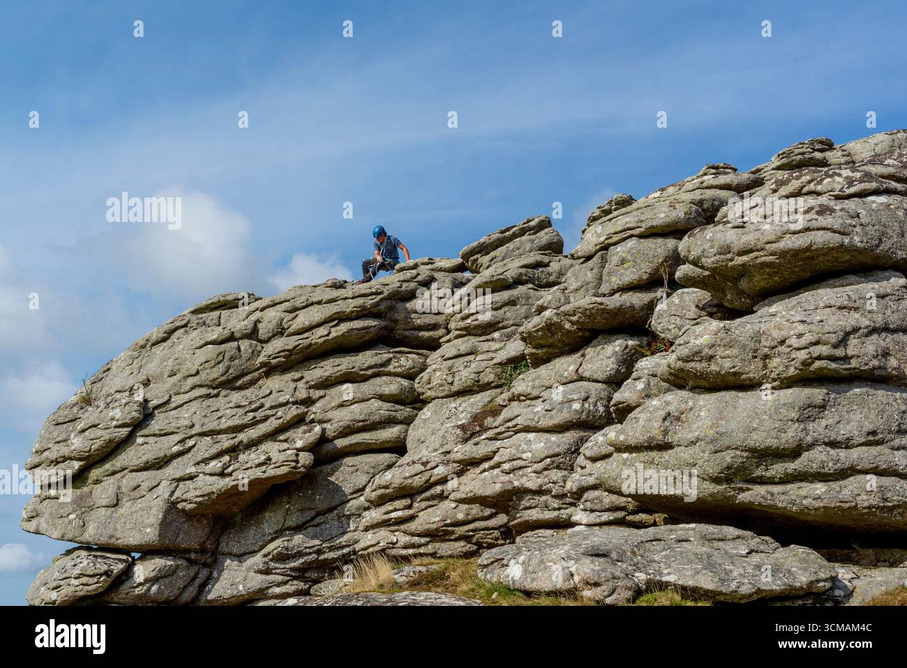 Arrampicatore su roccia a Hound Tor, Dartmoor, Devon Foto Stock