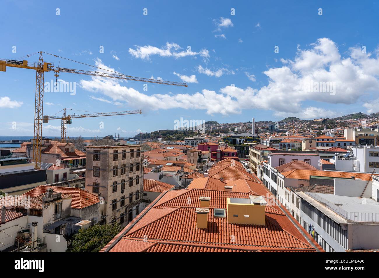 Vista panoramica della città di Funchal con tetti di tegole rosse e dell'oceano, Madeira, Portogallo Foto Stock