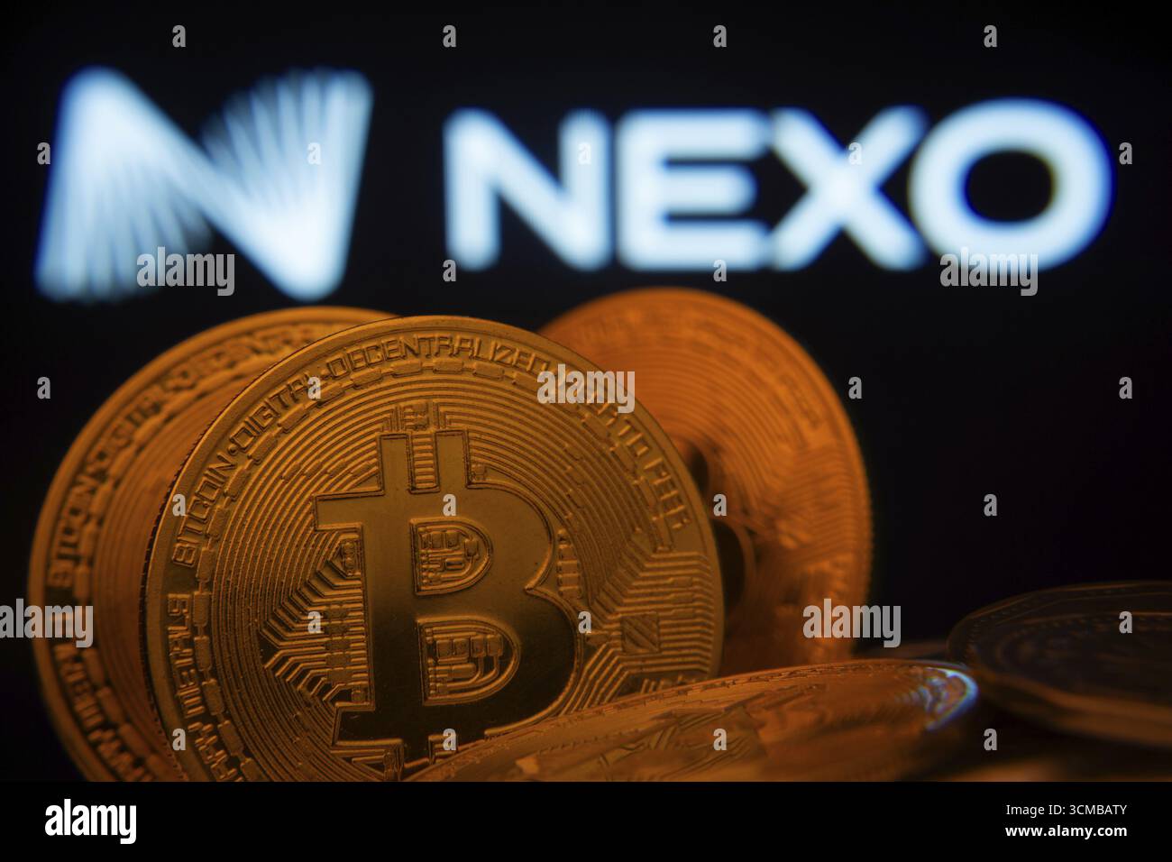 Dhaka, Bangladesh- 06 set 2025: Primo piano di Bitcoin Coins con il logo Nexo visibile su uno schermo sullo sfondo Foto Stock