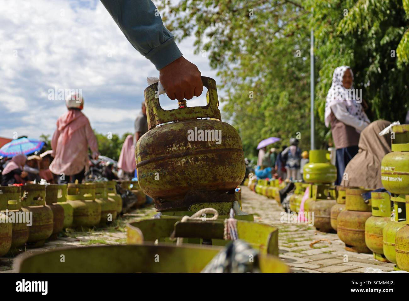 Banda Aceh, Aceh, Indonesia. 17 settembre 2025. Centinaia di bombole di gas da 3 kg sovvenzionate appartenenti alla comunità si sono schierate al mercato agricolo di banda Aceh City, provincia di Aceh, Indonesia mercoledì 17 settembre 2025. Pertamina Patra Niaga della regione di Sumbagut distribuì un ulteriore tubo GPL da 3 kg con un sussidio di 147.280 tubi o del 105% ad Aceh al fine di rafforzare l'approvvigionamento e non interferire con la distribuzione. Nel 2025 il governo indonesiano ha stanziato circa 87,6000 miliardi di dollari per sovvenzioni al GPL di 3 kg, con un bilancio totale di sovvenzioni all'energia e compensazioni di 394000 miliardi di dollari. (CR Foto Stock
