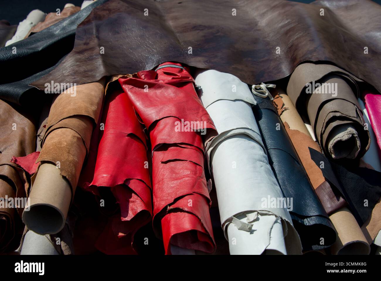 Rotoli di pelle e pelli in mostra, materiale artigianale utilizzato per pelletteria, moda e mobili. Foto Stock