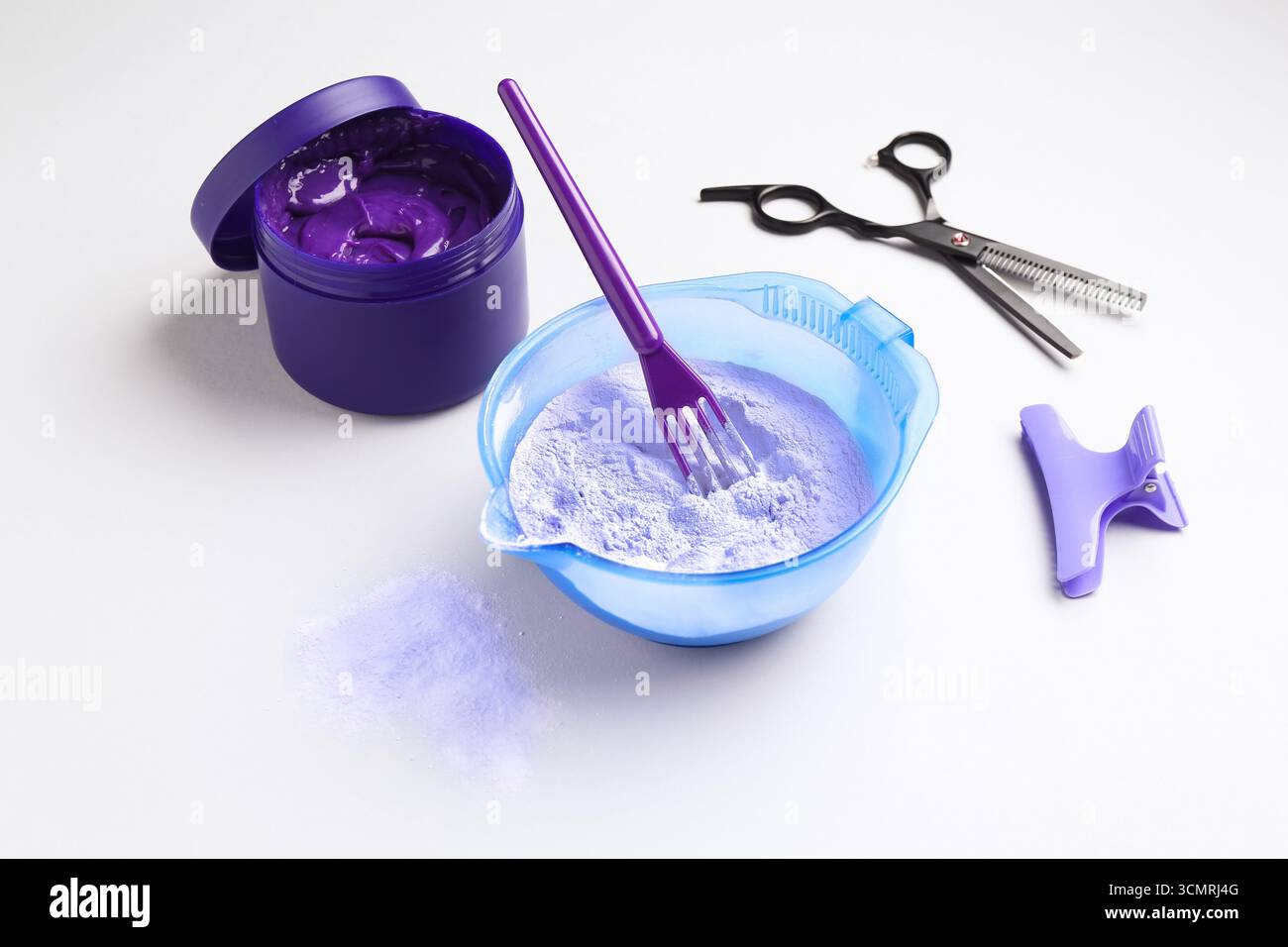 Prodotto per la cura dei capelli biondi e strumenti per parrucchieri su sfondo bianco Foto Stock