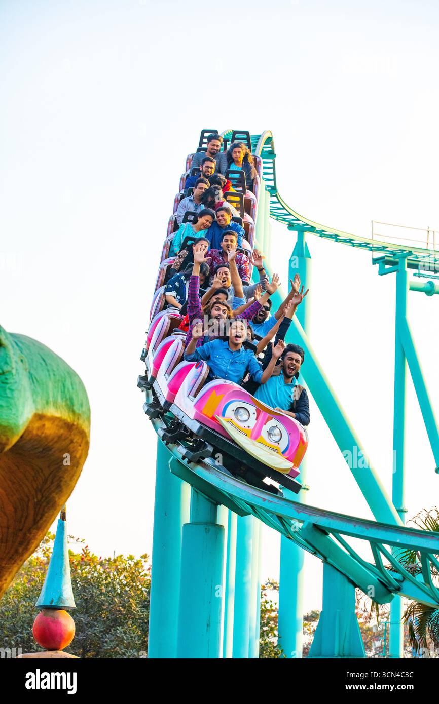Emozionati cavalieri su un Roller Coaster - emozionante giro nel parco divertimenti Foto Stock