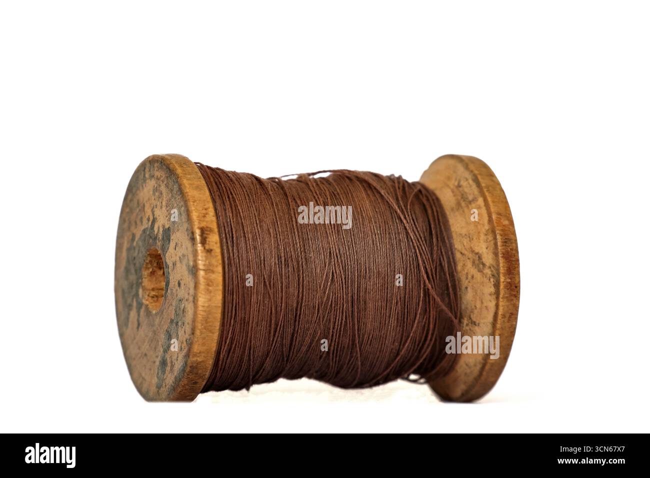 Bobina in filo di legno vintage su sfondo bianco Foto Stock