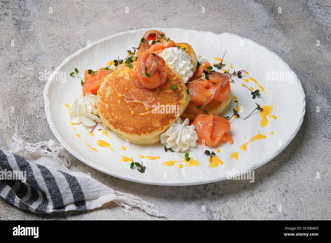 Gustate pancake gourmet con salmone affumicato e formaggio cremoso per una gustosa colazione o un brunch Foto Stock