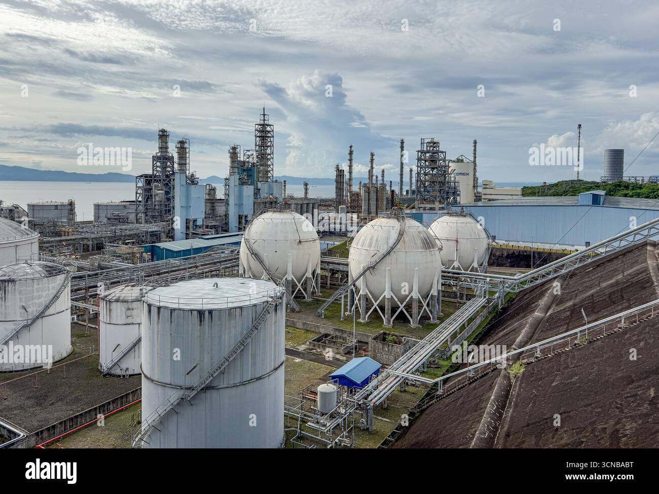 Batangas Bay, Filippine. 20 settembre 2025. L'impianto gas industriali Linde presso il JG Summit olefine comprende il complesso petrolchimico: Serbatoi cilindrici per stoccaggio liquidi, sfere Horton (recipienti a pressione sferica per immagazzinare gas liquefatti pressurizzati), unità di processo con colonne e pile di distillazione, torre svasata. Linde Filippine gestisce questo impianto in loco che produce azoto e idrogeno per supportare le operazioni petrolchimiche del JG Summit, comprese le prime e uniche unità di cracking della nafta e polimeri a valle del paese. Sfondo: Terminale Cemex/APO per cemento. Crediti: Kevin Izorce/Alamy Live News Foto Stock