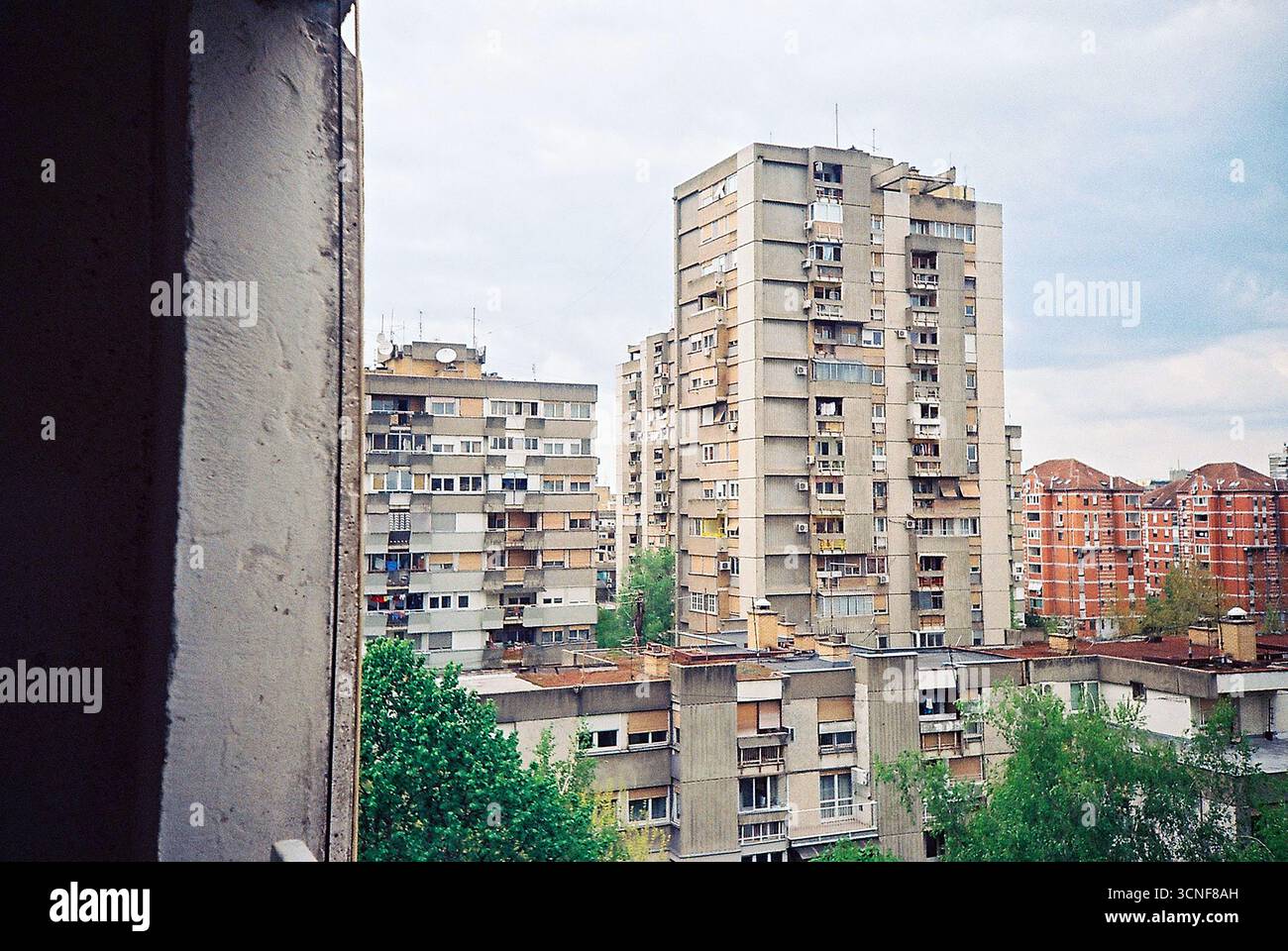 foto nalog di un edificio brutalista visto dalla finestra di un appartamento. Una vista tranquilla dell'architettura socialista e della vita quotidiana urbana. Foto Stock