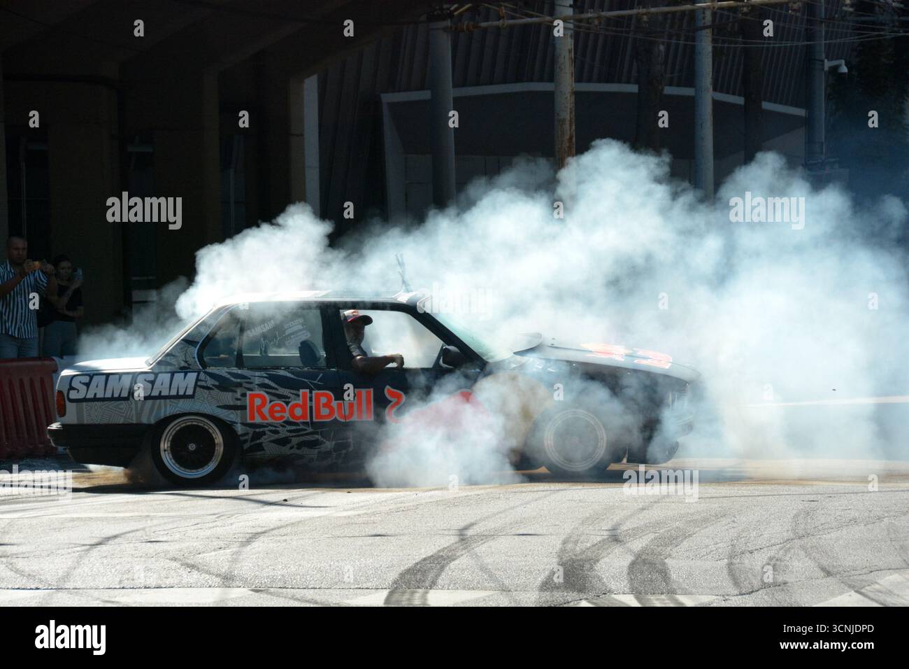 Sam Sam esegue un impressionante spettacolo di drift con una BMW E30 325i a Budapest, producendo un enorme fumo di pneumatici e intrattenendo la folla eccitata Foto Stock