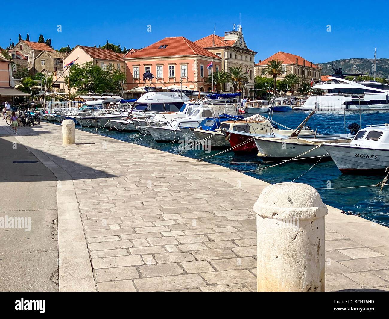 La splendida passeggiata e il lungomare nella storica città di Stari Grad, conosciuta per la sua architettura in pietra sull'isola croata di Hvar. Foto Stock