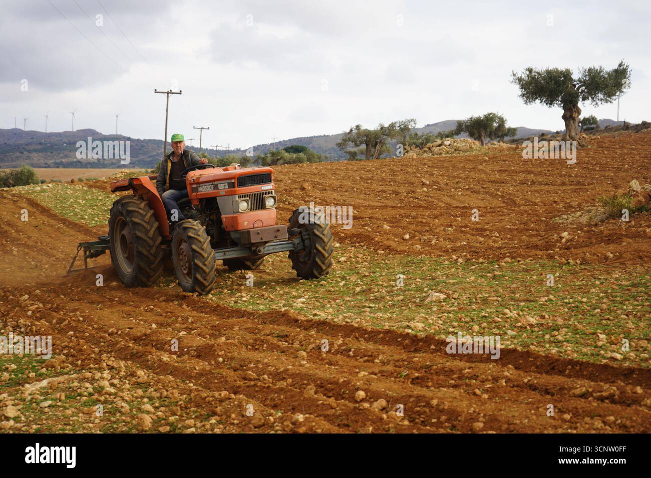 Un'immagine più ravvicinata di un contadino sul suo trattore kubota, che lavora la terra. l'immagine cattura lo sforzo e la dedizione coinvolti nella vita agricola rurale. Foto Stock Un'immagine più ravvicinata di un contadino sul suo trattore kubota, che lavora la terra. l'immagine cattura lo sforzo e la dedizione coinvolti nella vita agricola rurale. Foto Stock