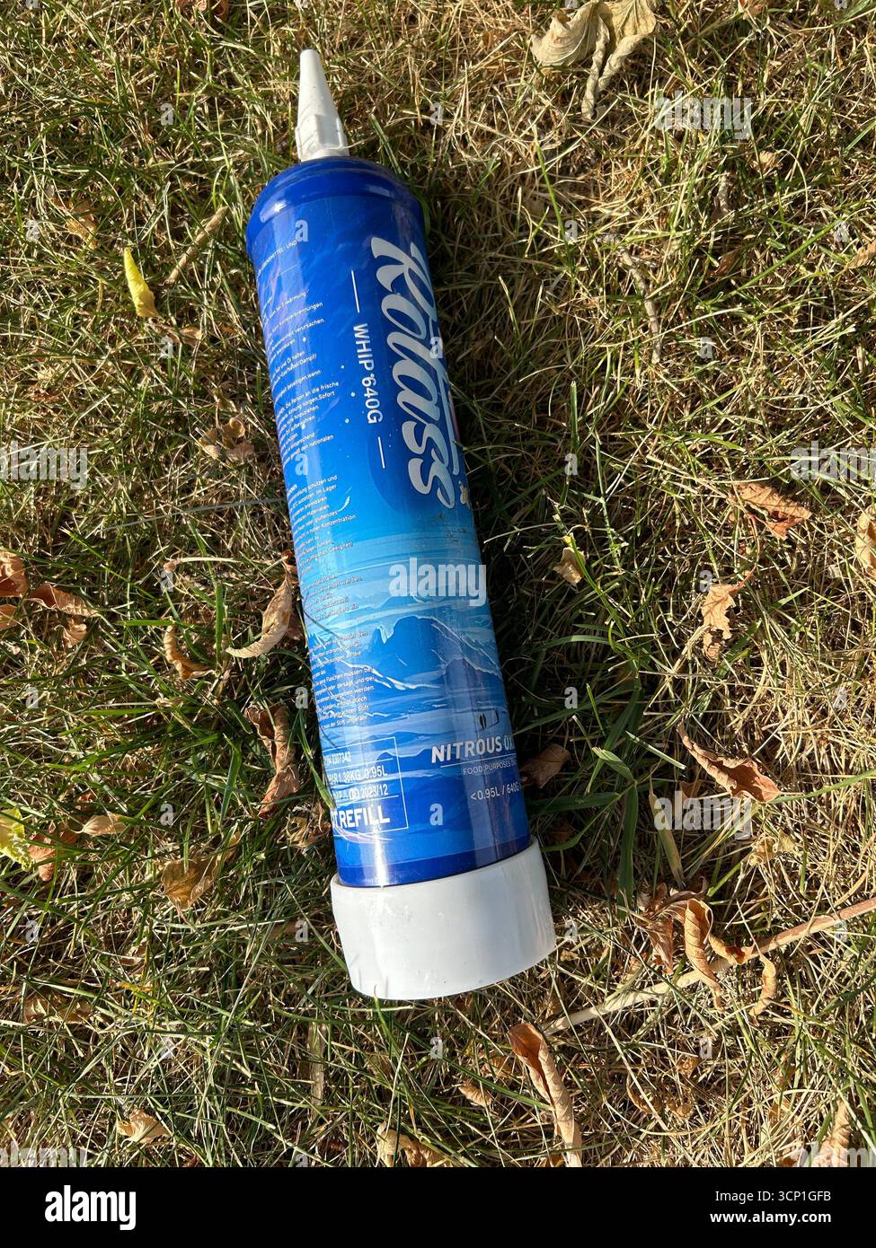 Qualcuno ha gettato una bottiglia di protossido di azoto completamente carica in una strada di periferia per i bambini. Foto Stock