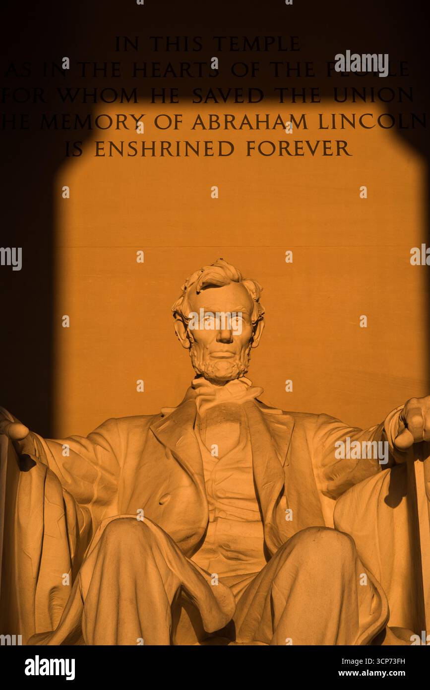 Lincoln Memorial Washington DC Vernal Equinox Sunrise // WASHINGTON DC - il Lincoln Memorial è illuminato dalla luce del sole durante l'alba dell'equinozio vernal, che si verifica quando il sole sorge direttamente a est. Nelle mattine limpide, questo allineamento fa splendere la luce del sole direttamente nella camera principale del monumento, illuminando la statua di Abraham Lincoln. L'iscrizione sopra la statua recita: "In questo tempio come nei cuori del popolo per il quale ha salvato l'Unione, la memoria di Abraham Lincoln è consacrata per sempre". Il memoriale è un monumento nazionale in onore del 16° presidente degli Stati Uniti, Abraha Foto Stock