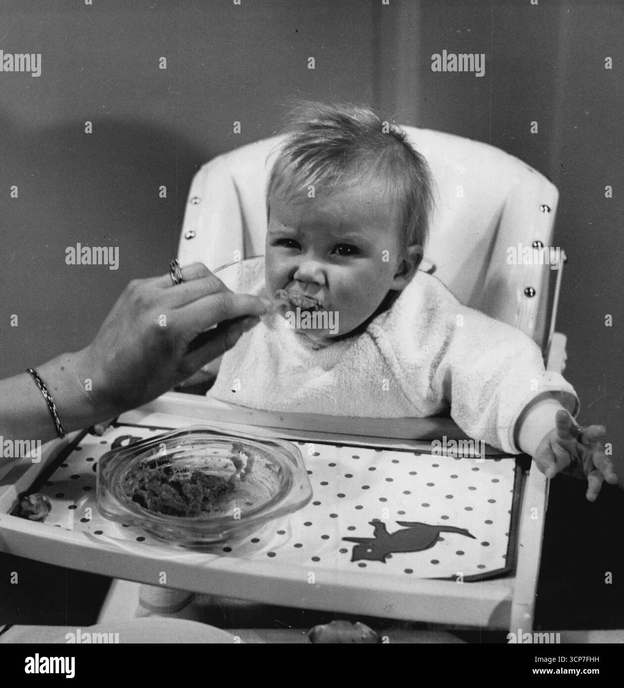 Nove mesi: 'È arrivato - ma mi piace' di nove mesi, Mary è fuori dalla routine del bambino e mangia come una della famiglia. Sia i pasti a base di latte mattutino che quelli serali sono stati abbandonati e ora fa colazione alle 8 circa, cena tra le 12,30 e le 13 e tè alle 5. Mangia una buona dieta variegata, con tutta la frutta e la verdura accuratamente setacciata, beve il normale latte bollito, succo d'arancia e molta acqua. Il suo peso è salito a 18 libbre. Alla fine Mary ha due denti i due anteriori superiori. 8 febbraio 1932. (Foto di Tom Blau, camera Press). Foto Stock