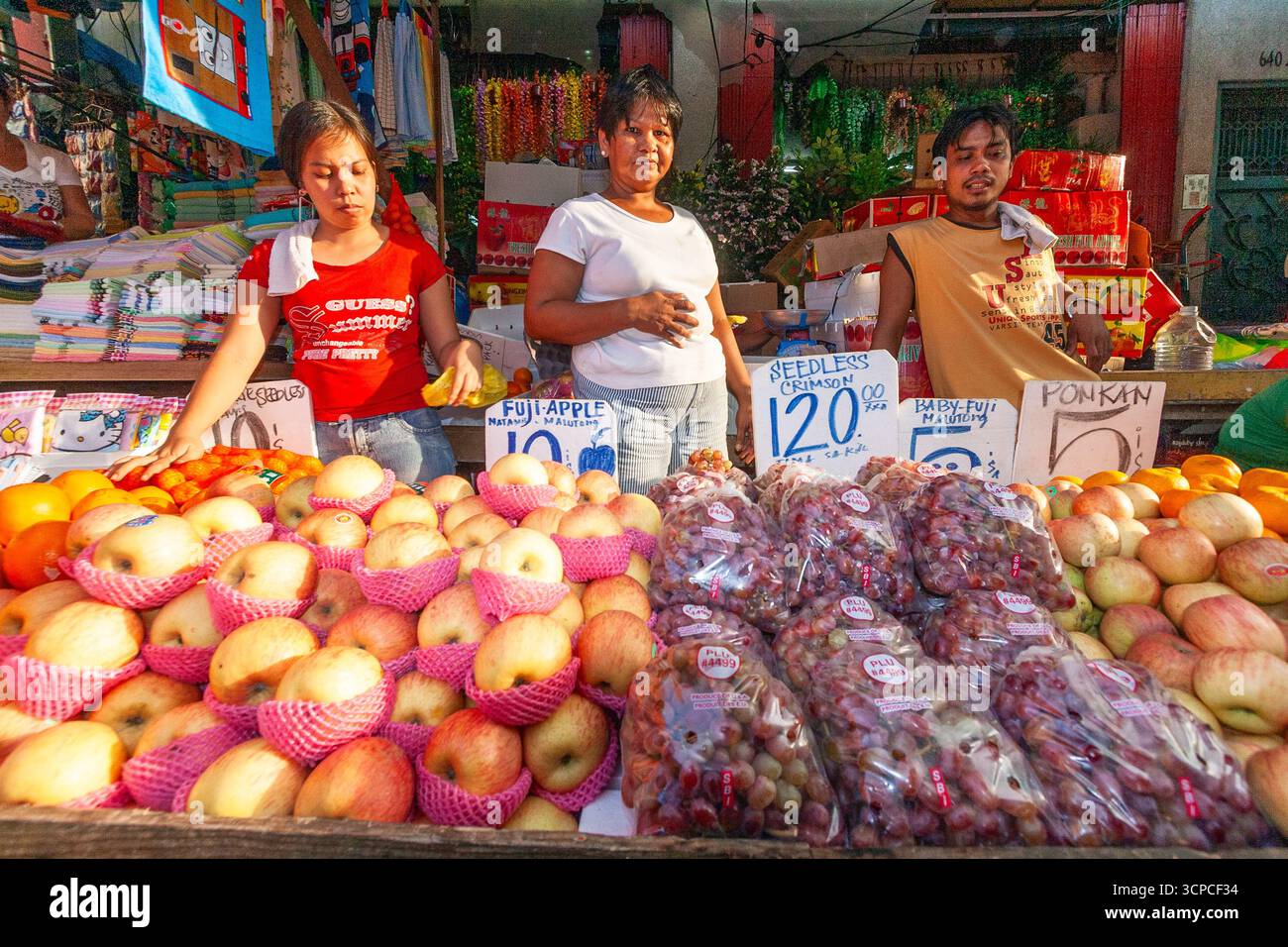 Venditori di frutta lungo una strada in un mercato di Manila Foto Stock