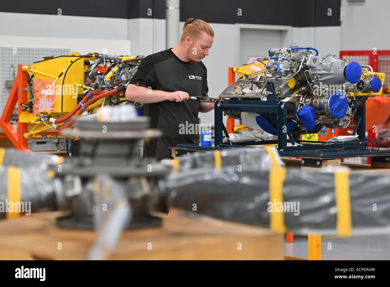 Tussenhausen Mattsies, Germania. 25 settembre 2025. Costruzione di aeromobili, operaio qualificato, meccanico di aerei che assembla un motore. Grob è un produttore tedesco di apparecchiature originali (OEM) che produce anche aeromobili realizzati con materiali compositi con fibre di carbonio. Credito: dpa/Alamy Live News Foto Stock