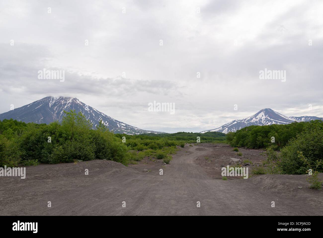 Paesaggio con strada sterrata per i vulcani Avachinsky e Koryaksky a Kamchatka, Russia Foto Stock