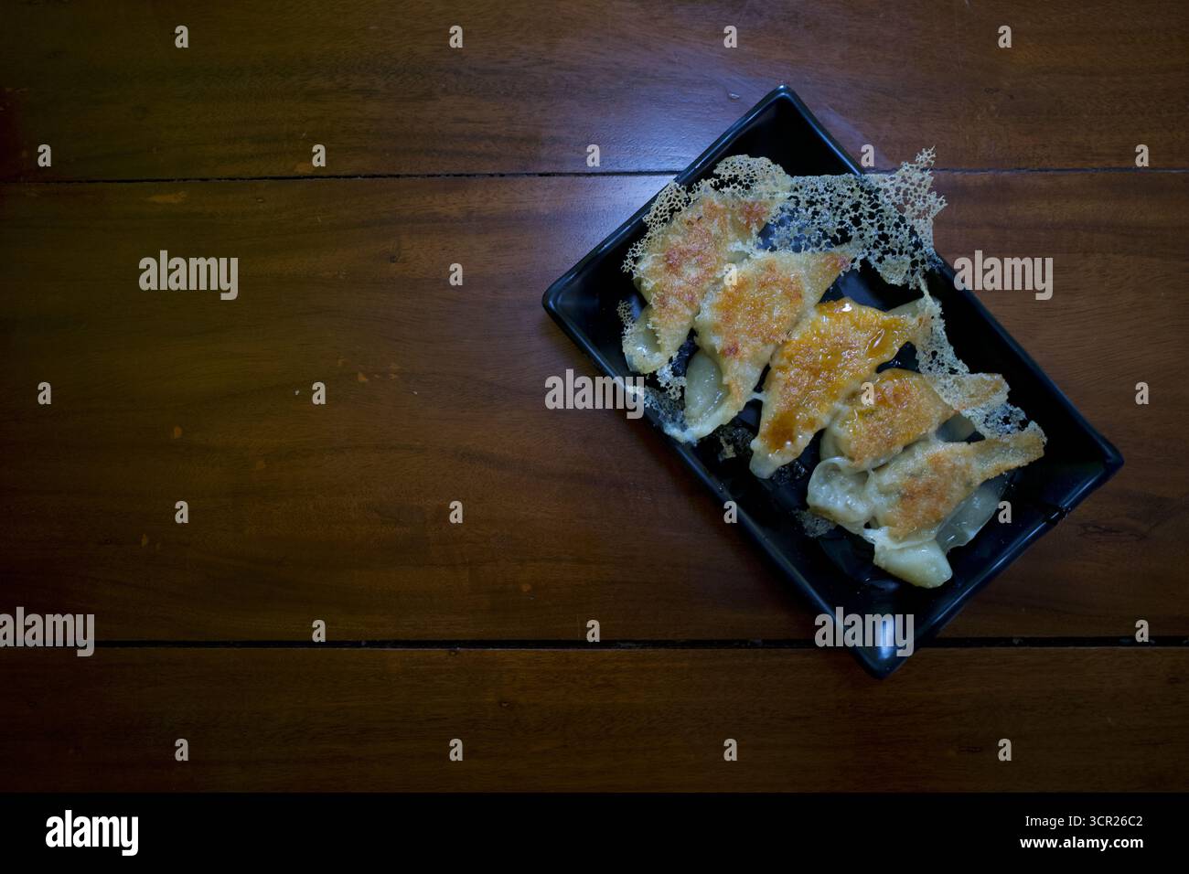 Gyoza giapponese tradizionale con carne su un tavolo di legno. Foto Stock