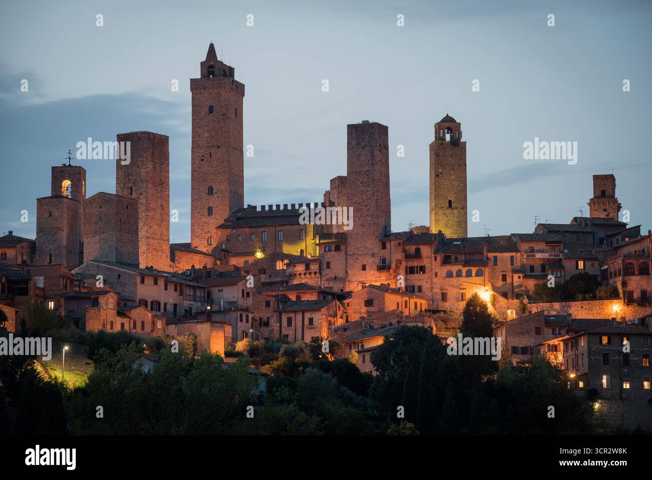 Città storica di San Giminiano con tutte le sue torri illuminate in una serata estiva. Provincia di Siena, Toscana, Italia Foto Stock