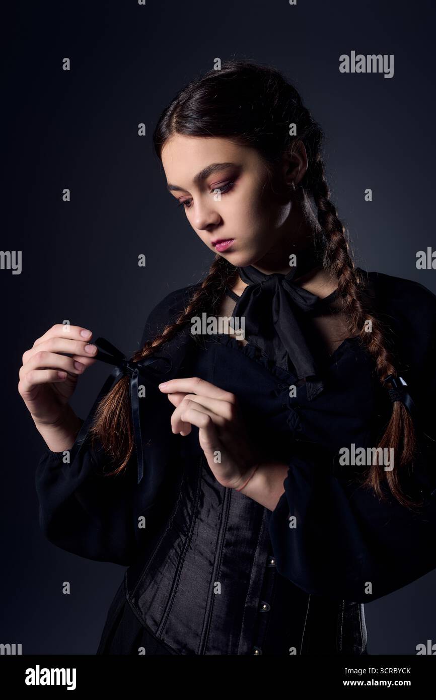 Una ragazza vestita con un costume di Halloween in stile gotico cattura l'essenza di ottobre. Foto Stock