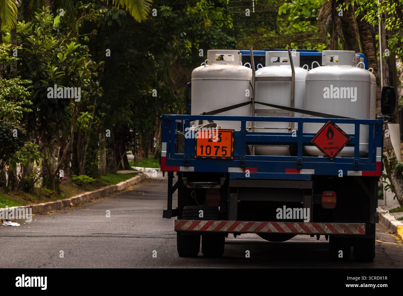 Carrello che trasporta bombole di gas infiammabili in un'area urbana in Brasile. Illustra le sfide e i rischi legati al trasporto di materiali pericolosi. Foto Stock
