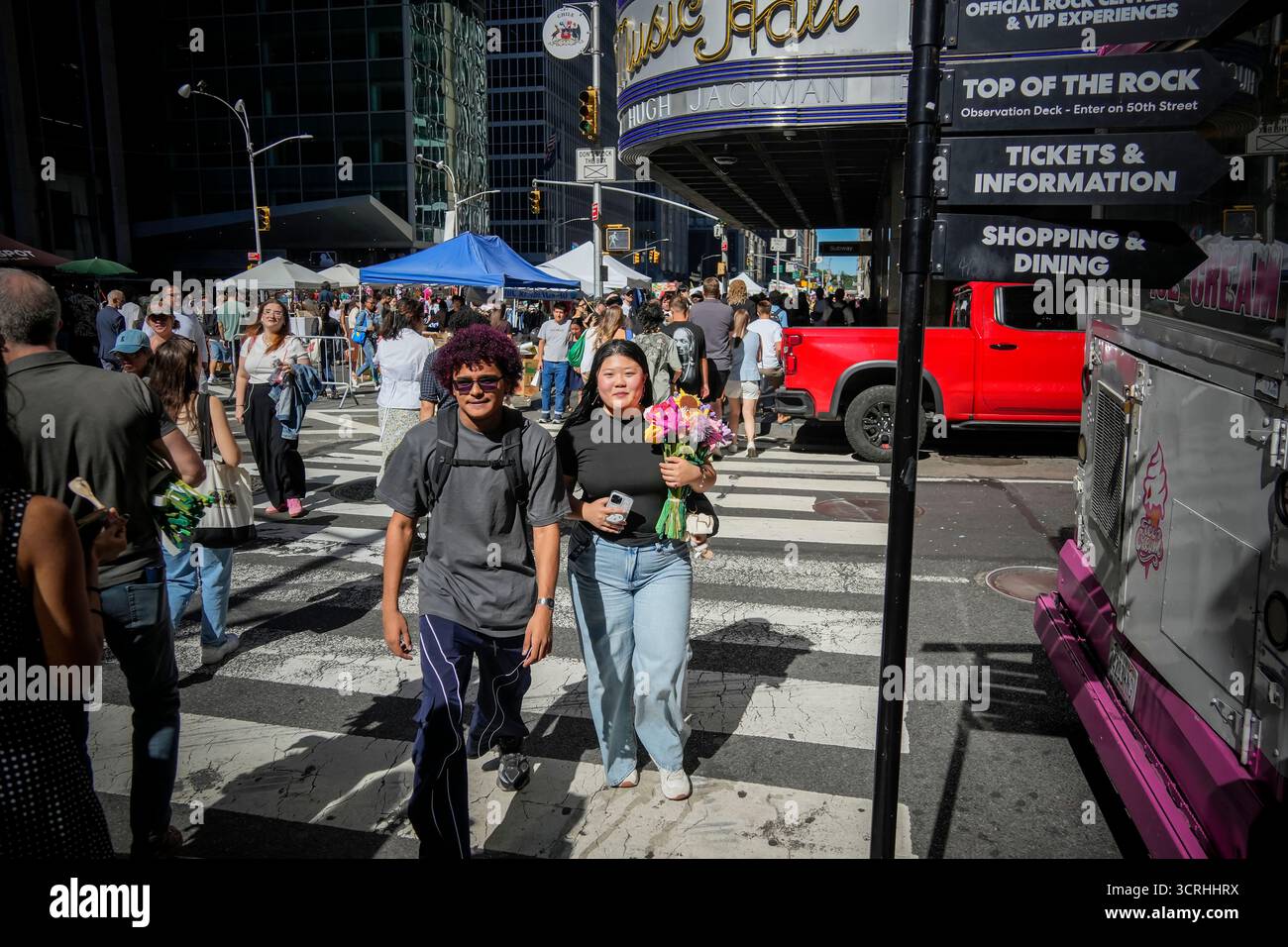 Gli acquirenti con i loro fiori di peluche lasciano l'installazione artistica immersiva, Flower Market 2,0, dell'artista australiano CJ Hendry al Rockefeller Center di New York sabato 20 settembre 2025. I partecipanti dopo le ore di attesa online hanno ricevuto un fiore gratuito con la possibilità di acquistare altri per completare i loro mazzi. (© Richard B. Levine) Foto Stock