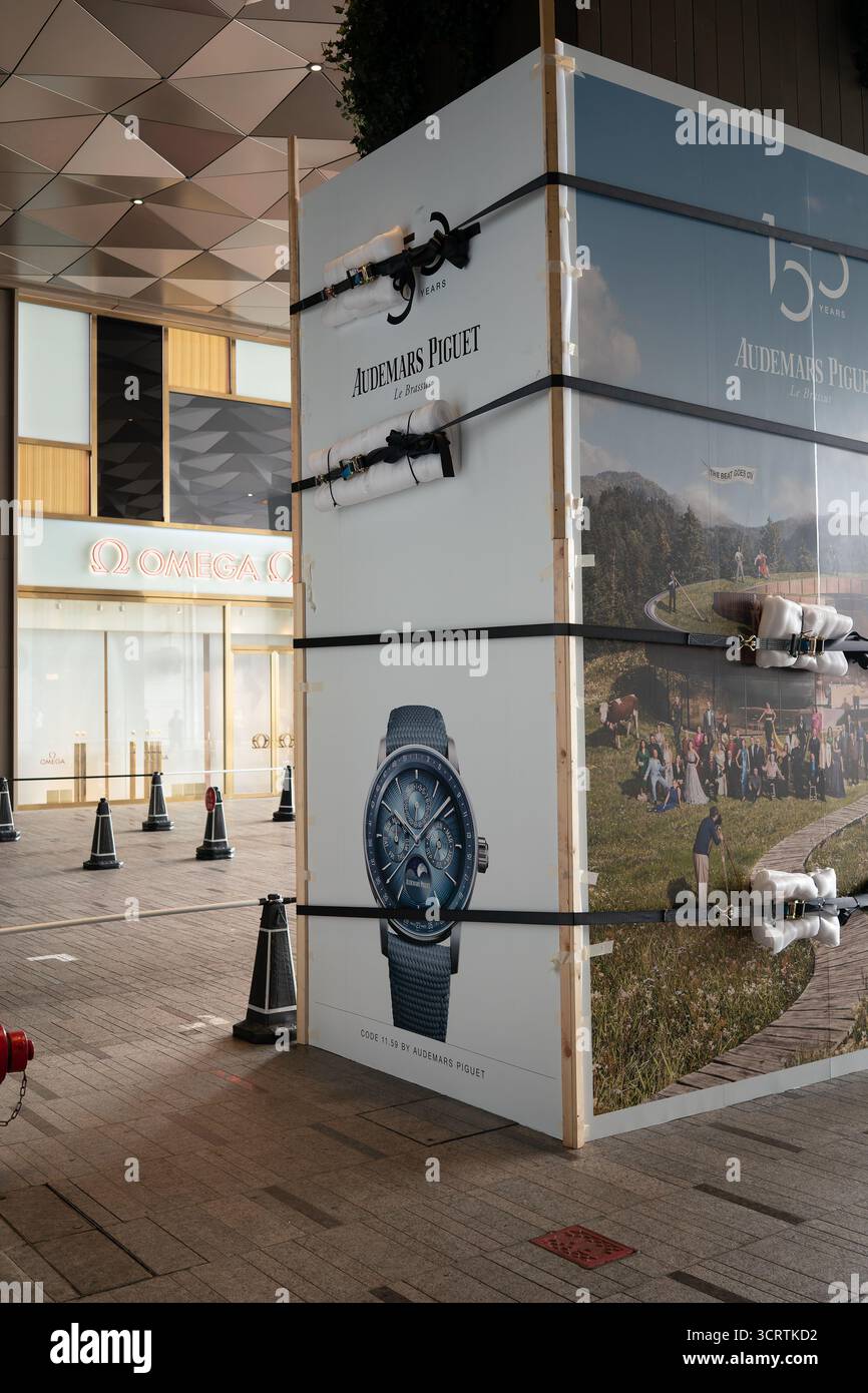 Hong Kong, Cina - 23 settembre 2025: Un cartellone pubblicitario per orologi Audemars Piguet è fissato con cinghie dentate imbottite per evitare danni Foto Stock