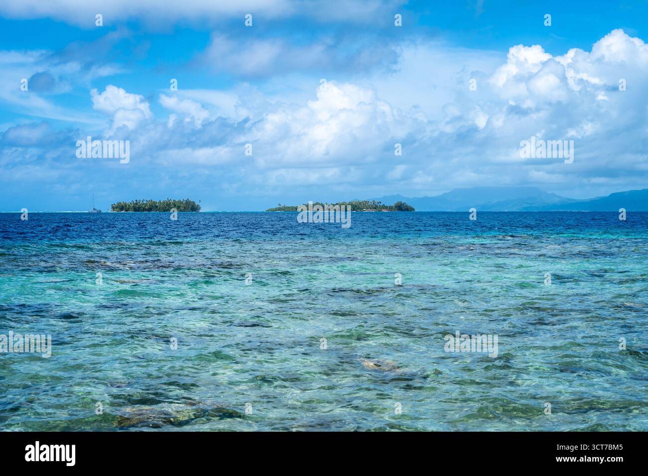 Acque cristalline circondano il moto e la barriera corallina dell'isola di Tahaa, offrendo una pittoresca vista della laguna nella Polinesia francese Foto Stock