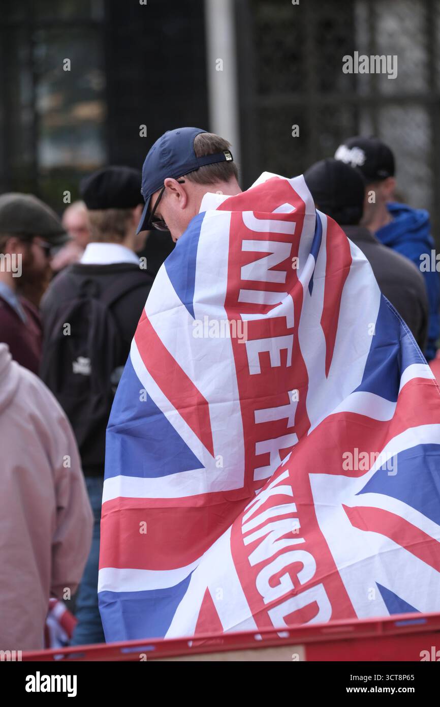 Bristol, Regno Unito. 5 ottobre 2025. I patrioti di destra con le bandiere di San Giorgio e dell'Unione si riuniscono al Cenotafio di Bristol, per protestare contro l'immigrazione. Gli attivisti, molti che si identificano come antifascisti, che credono che migranti e rifugiati debbano essere accolti, hanno organizzato una contro-protesta. Avon e la polizia di Somerset hanno adottato misure per consentire una protesta pacifica, ma intendono tenere tutti al sicuro tenendo separate le due parti. Crediti: JMF News/Alamy Live News Foto Stock
