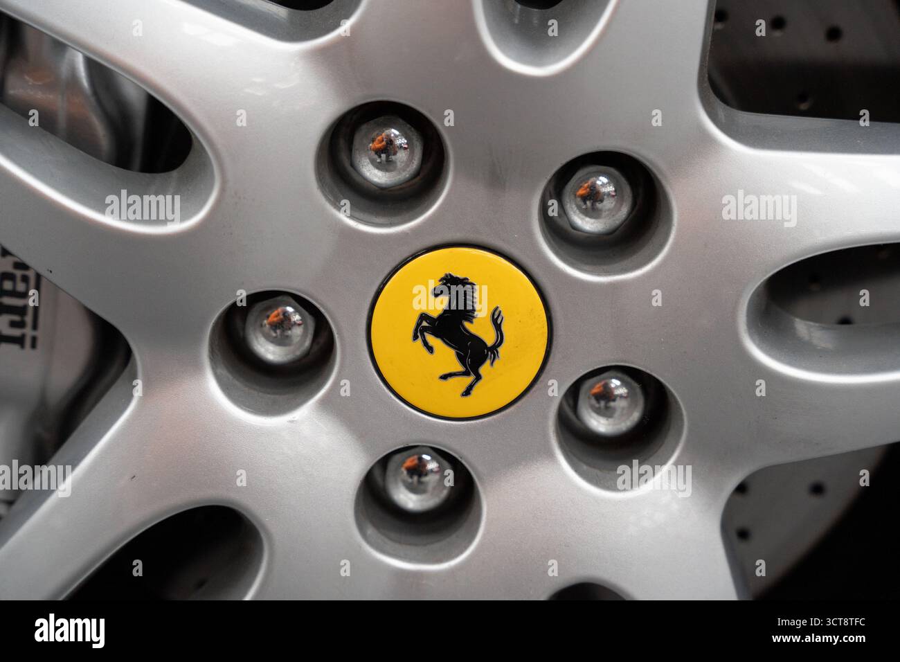 Logo Ferrari cavallino su cerchi in lega argento con dadi di fissaggio Foto Stock