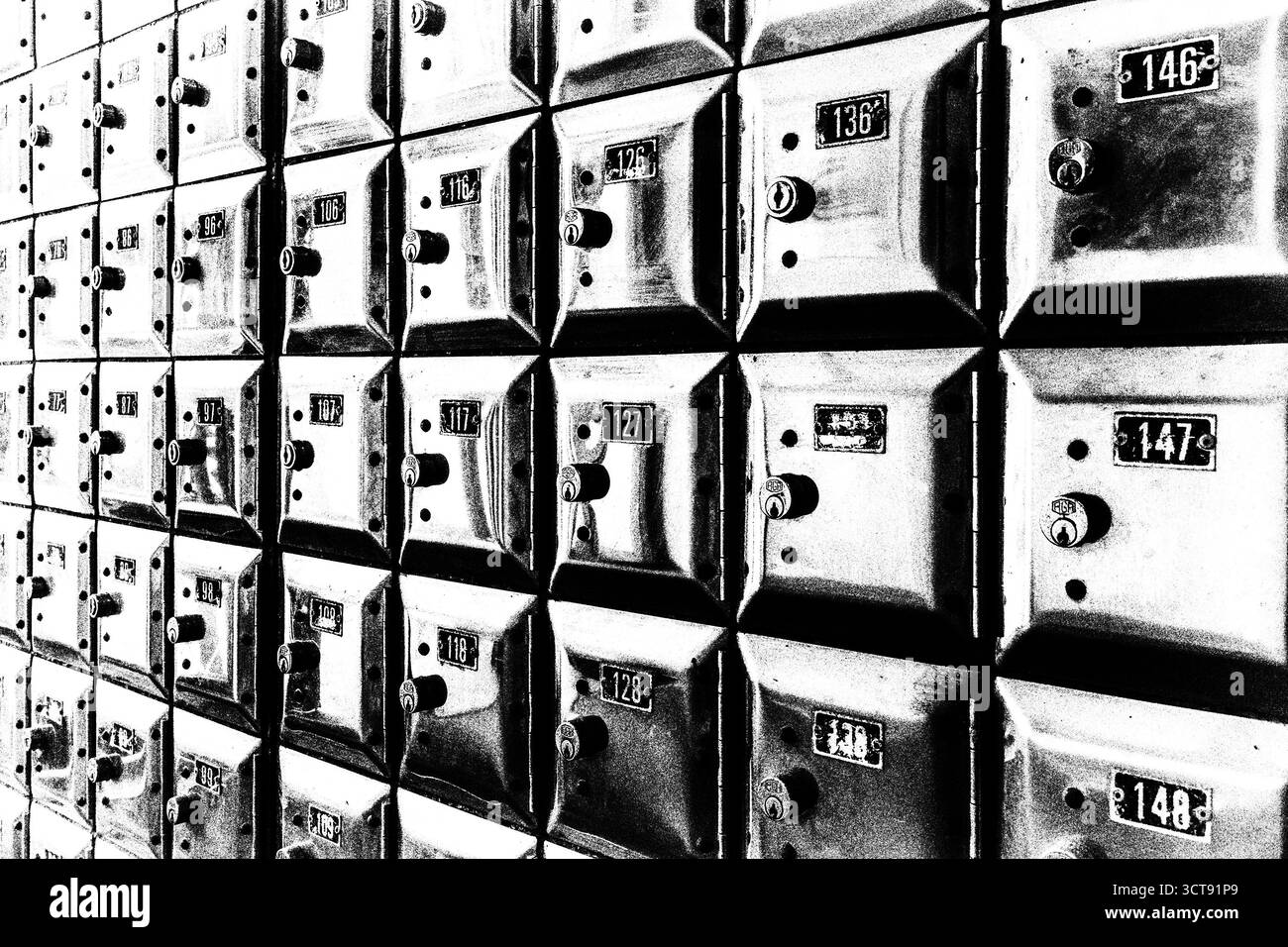 Un muro pieno di file di vecchie cassette di valore in metallo lucido Foto Stock