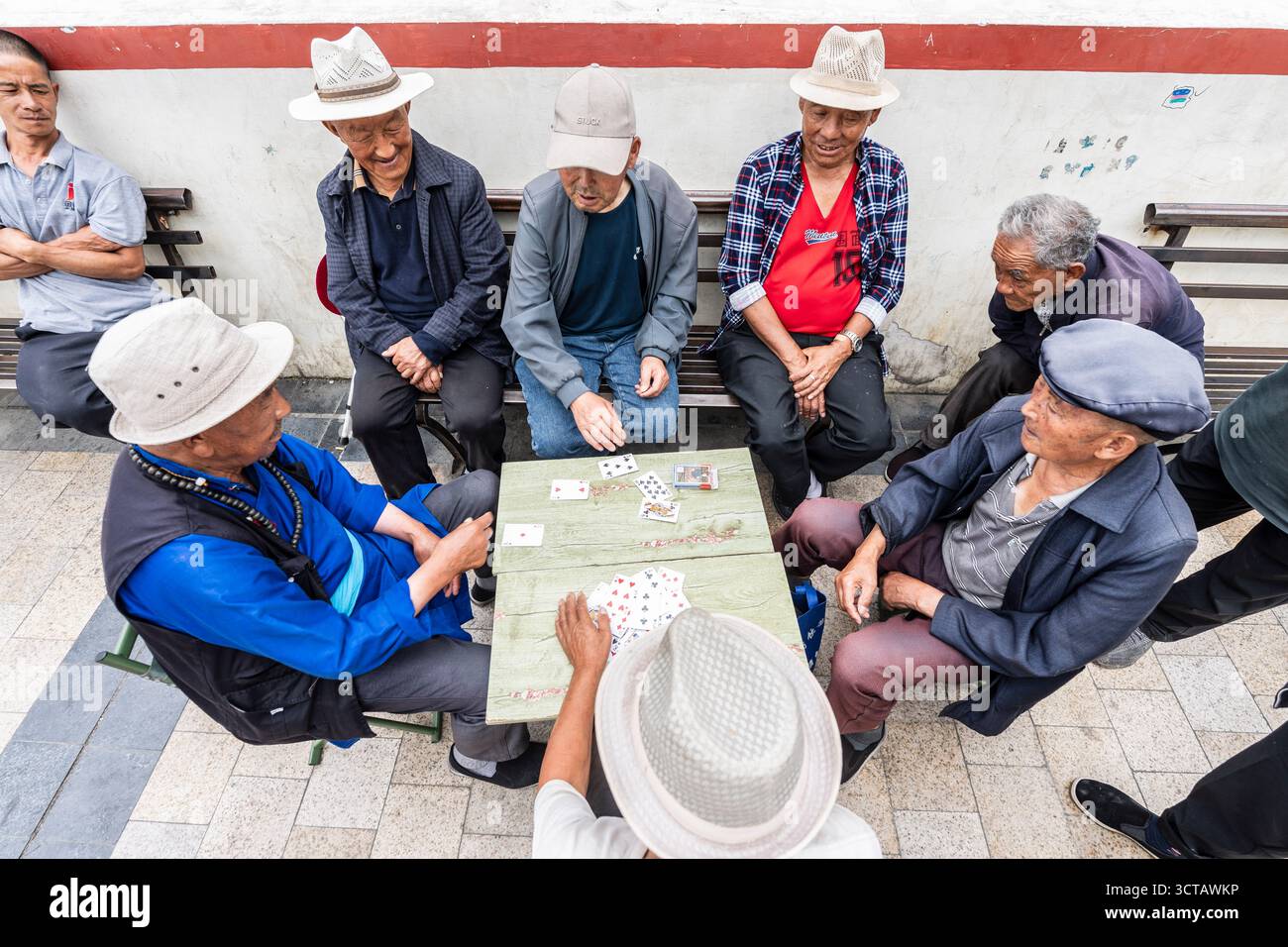 Uomini anziani che giocano a carte per strada, Xiaojin, contea di Ngawa, prefettura autonoma tibetana di Garzê, Sichuan, Cina. Foto Stock