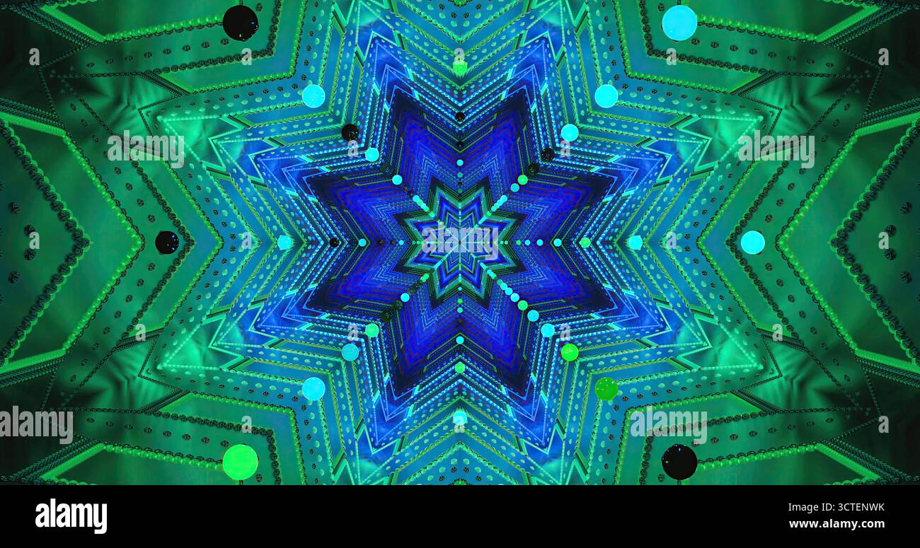 Questa scena presenta un vivace design a forma di stella illuminato in sfumature di blu, verde e nero. Foto Stock
