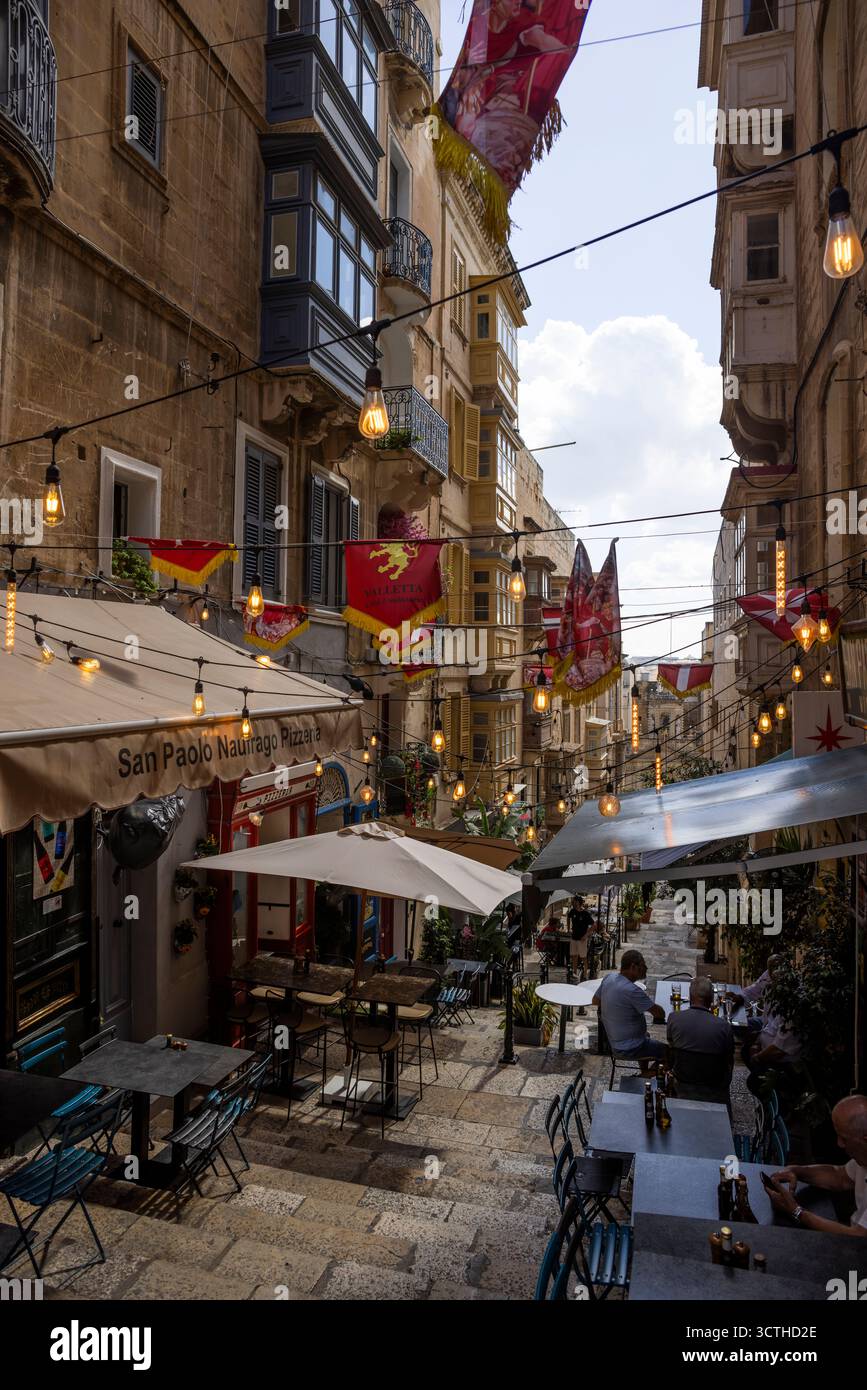 Scena di strada con il ristorante Pizzeria San Paolo Naufrago, St. Lucia's Street, il-Belt Valletta, Malta. Foto Stock