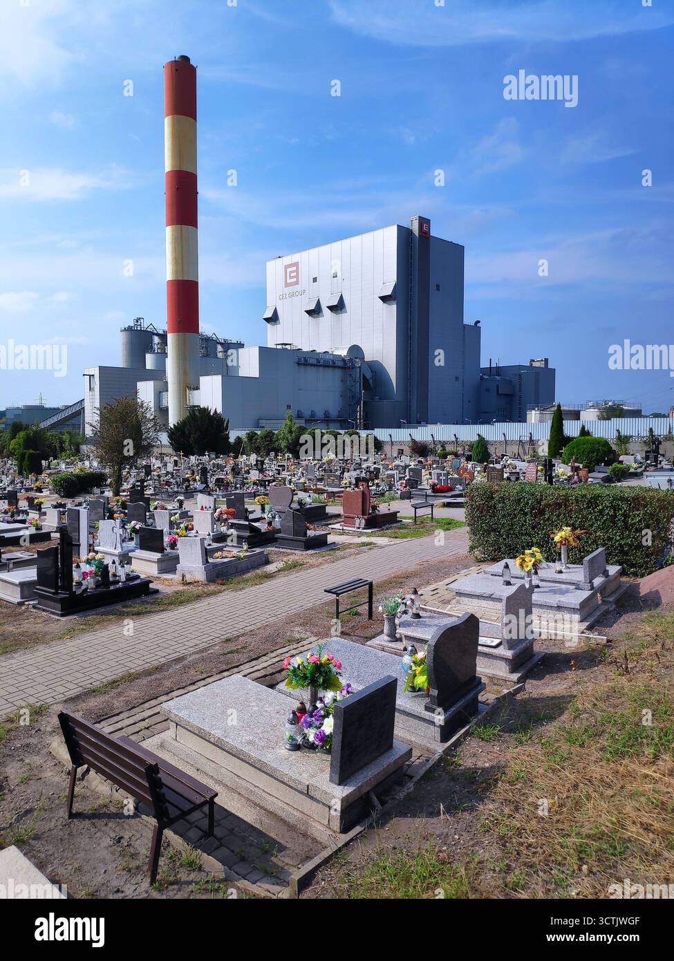 CHORZOW, POLONIA - 1 SETTEMBRE 2024: Cimitero con grande impianto industriale in background a Chorzow, Polonia. Foto Stock