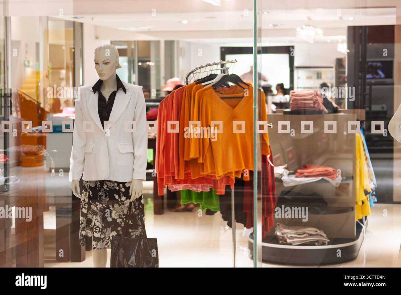 vetrina con manichino in un negozio di abbigliamento boutique in una strada trafficata nel quartiere commerciale degli affari Foto Stock