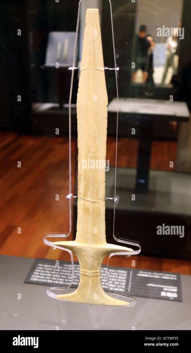 Una fotografia di un pugnale in pietra coreana dell'età del bronzo dalla collezione del Museo Nazionale di Gyeongju. L'età del bronzo in Corea è spesso considerata iniziata intorno al 900-800 a.C., anche se la transizione all'età del bronzo potrebbe essere iniziata già nel 2300 a.C. Questo periodo è cruciale per comprendere l'emergere di strumenti e armi in bronzo, così come lo sviluppo di società più complesse. c. 800 a.C. Foto Stock