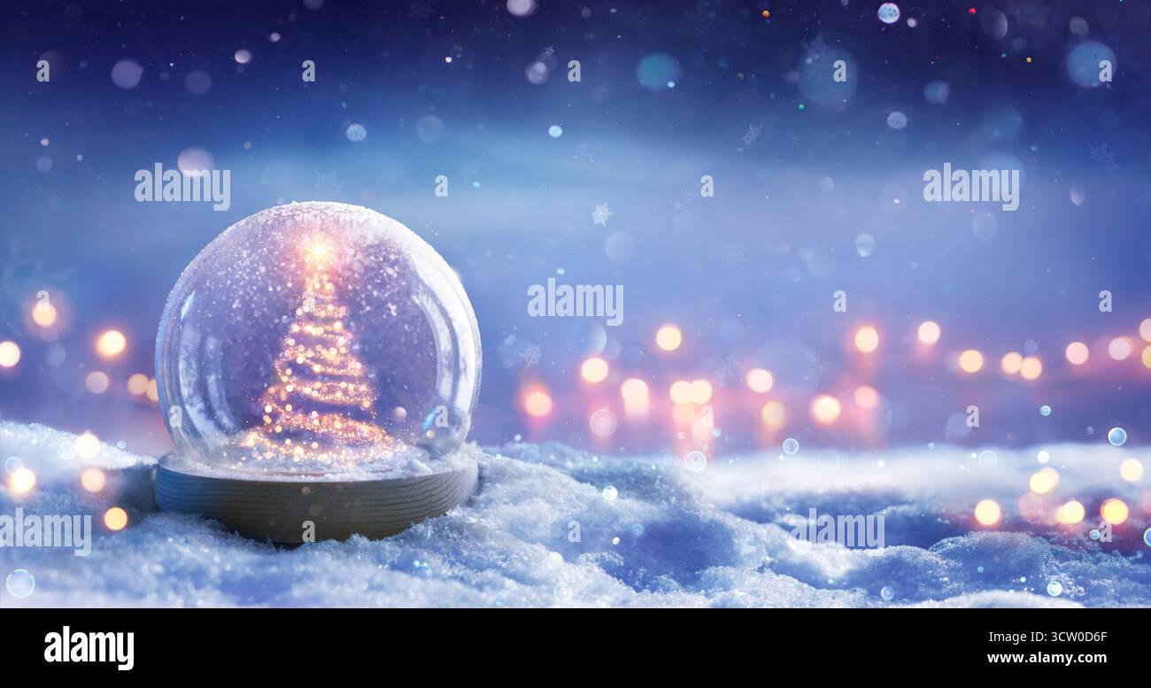 Albero di Natale in Snowglobe sulla neve di notte con scintillante stella e in inverno sullo sfondo - luci bokeh festive Foto Stock