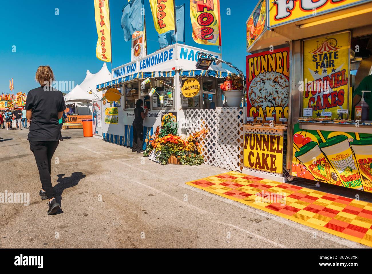 Persone che camminano lungo Fair Order Food Foto Stock