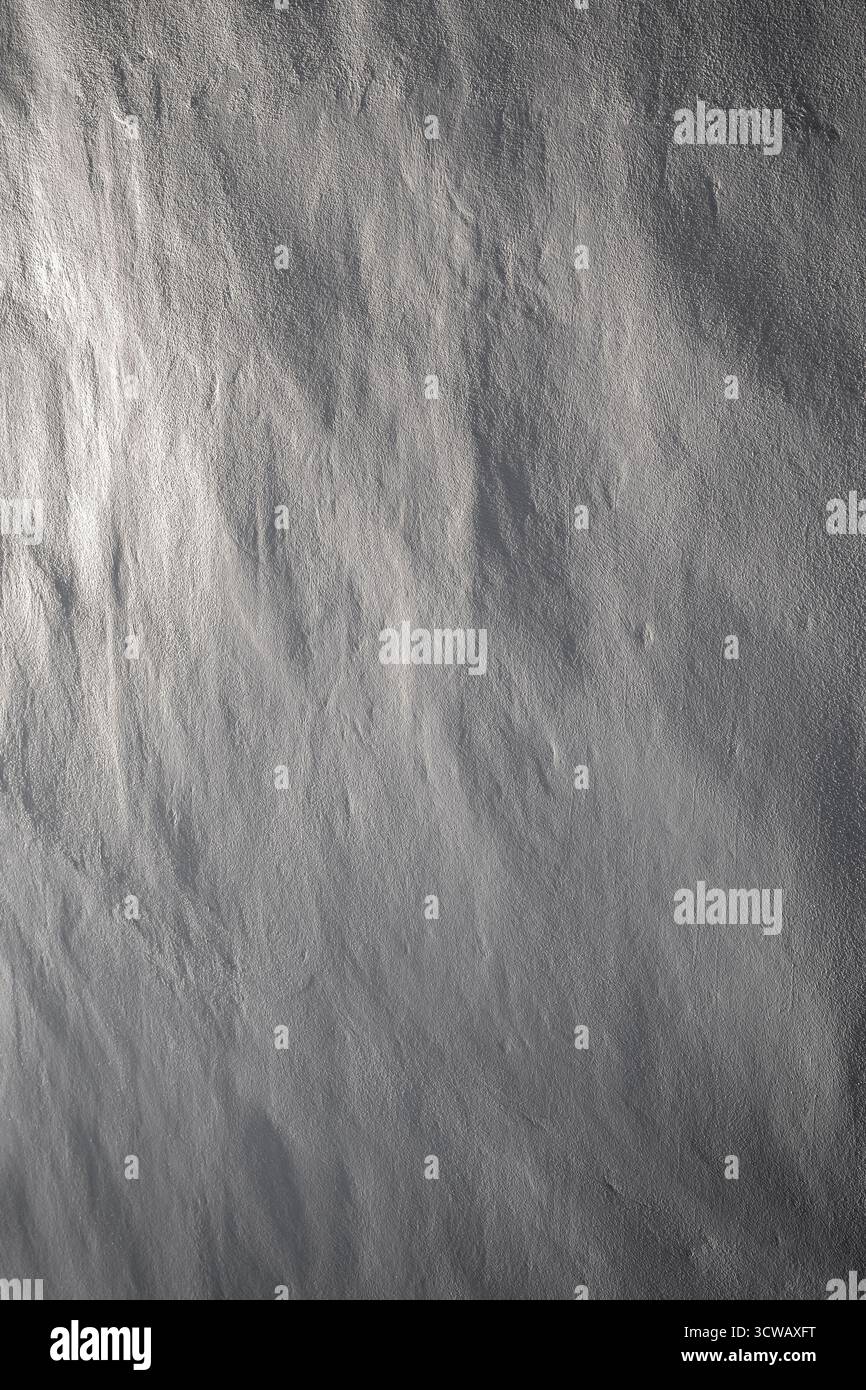 Primo piano di un muro di pietra dipinto pulito e irregolare in bianco e nero. Una luce laterale bellissima crea ombre morbide. Sfondo strutturato astratto, spazio di copia Foto Stock