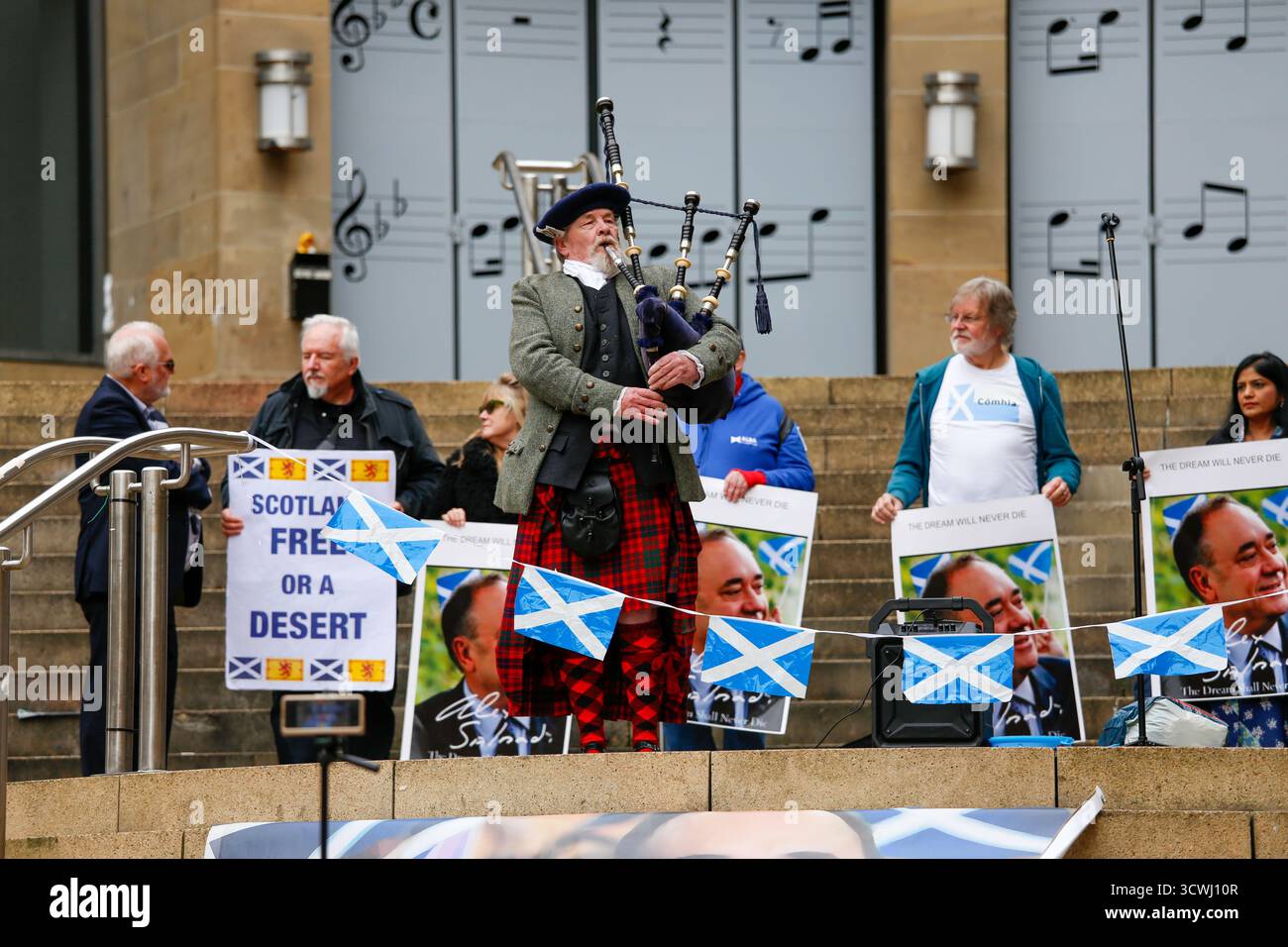 Glasgow, Scozia, Regno Unito. 12 ottobre 2025. I sostenitori dell'ex primo ministro Alex Salmond si sono riuniti a Glasgow per celebrare il primo anniversario della sua morte. I partecipanti hanno reso omaggio con discorsi, fiori e momenti di riflessione in onore dell’eredità politica dell’ex leader del SNP e dell’impatto sull’indipendenza scozzese. Crediti: Jacob Hughes/Alamy Live News Foto Stock