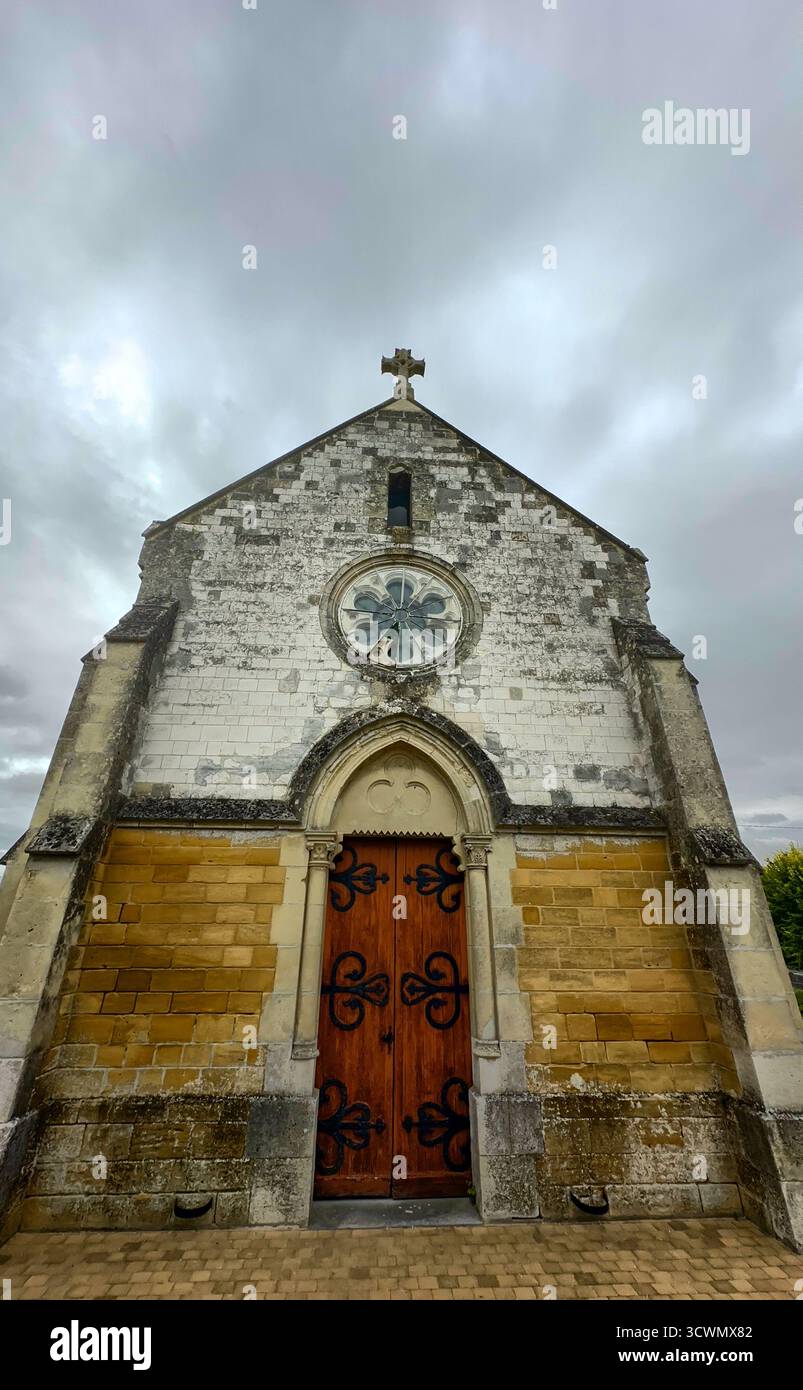 Bergnicourt, Rethel, Ardenne, Grand-Est, Francia, il 28 agosto 2025, Una vecchia cappella splendidamente realizzata, caratterizzata da un'affascinante porta in legno e un orologio ornato, adagiata su un cielo lunare Foto Stock