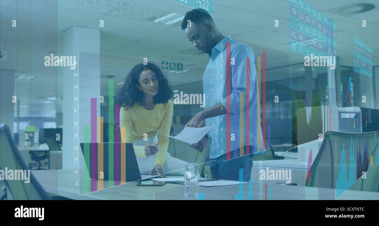 Indica la donna in maglione giallo che esamina i documenti con l'uomo in camicia blu in ufficio, con la penna Foto Stock