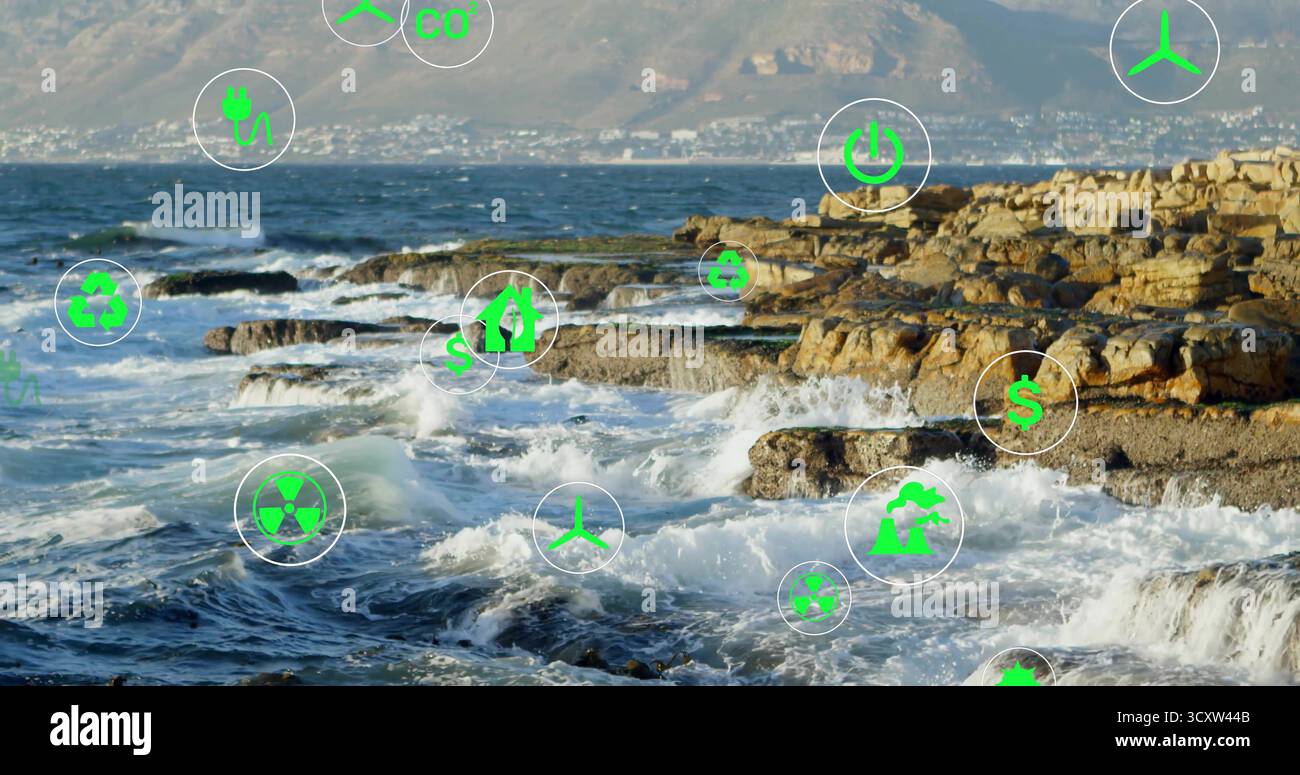 Mostra la costa rocciosa con onde che si infrangono sulla riva, mostrando cerchi di icone di energia verde traslucide Foto Stock