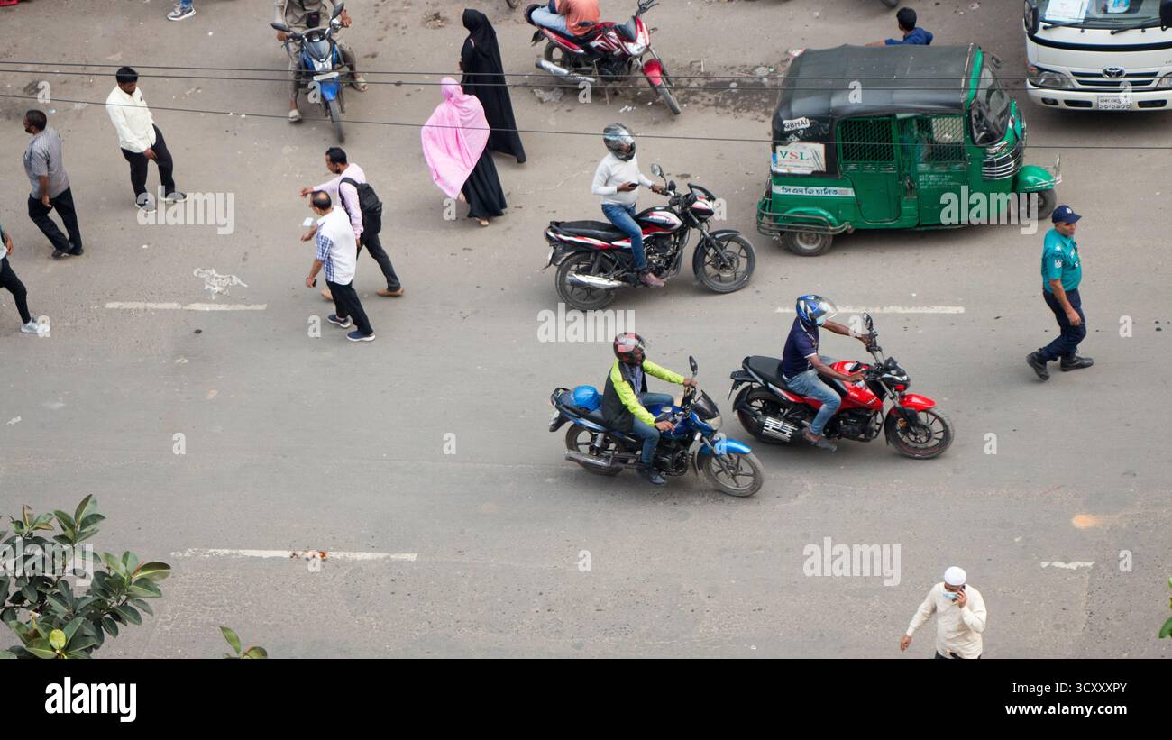 Strada trafficata vista dall'alto vita urbana pedoni moto risciò traffico trasporto su strada area affollata spostamenti locali vita quotidiana. Foto Stock