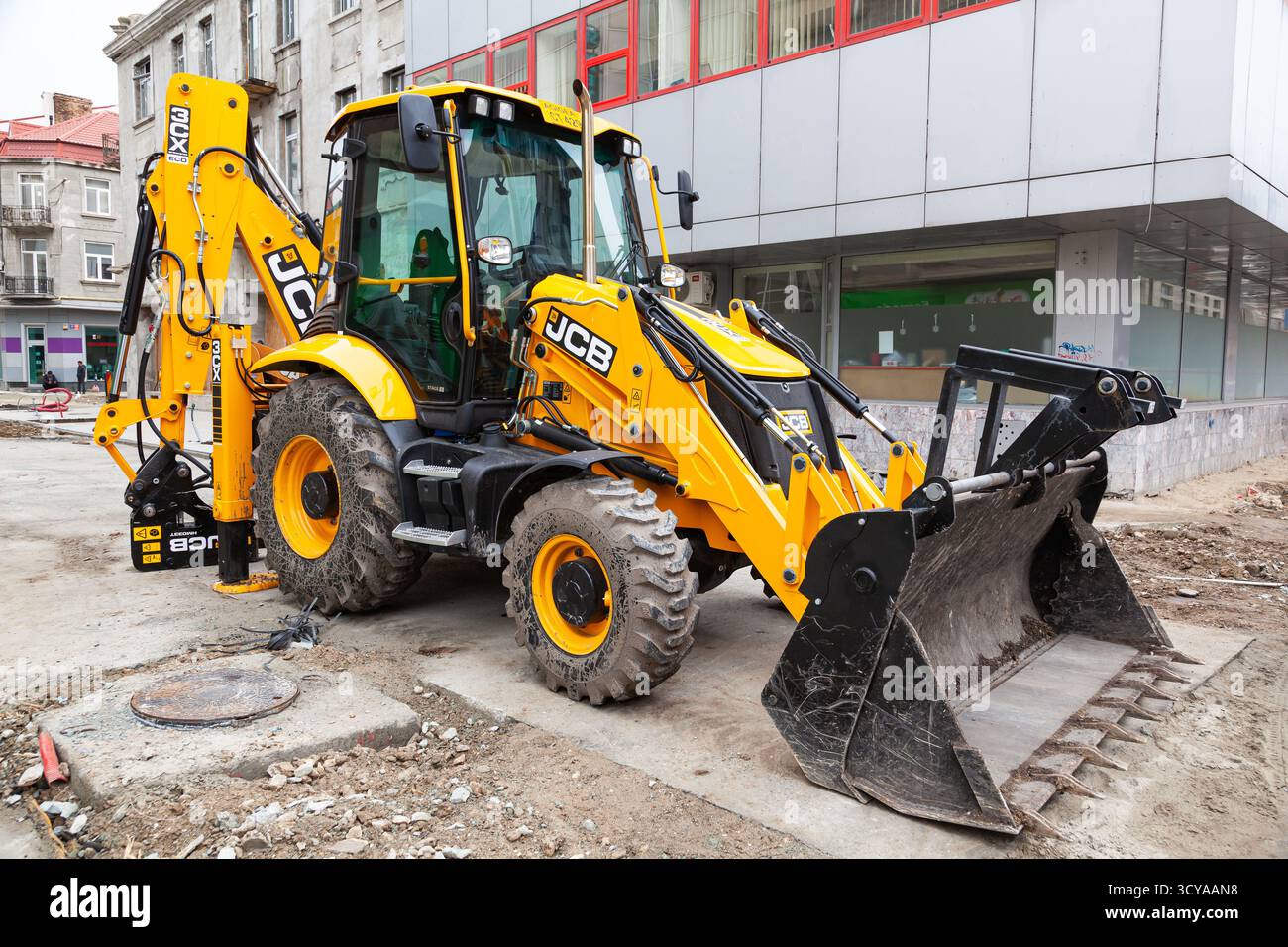 Trattore giallo JCB con benne idrauliche anteriori e posteriori Foto Stock