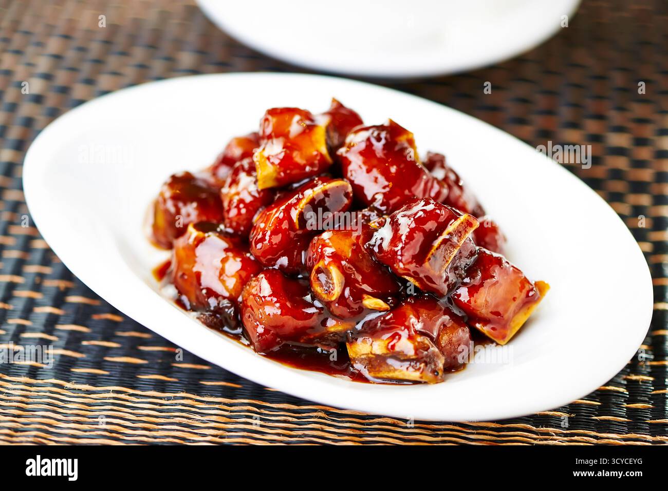 Costolette di maiale dolce e aspro servite nel piatto con vista laterale dell'antipasto Braised Asian Cuisine Foto Stock